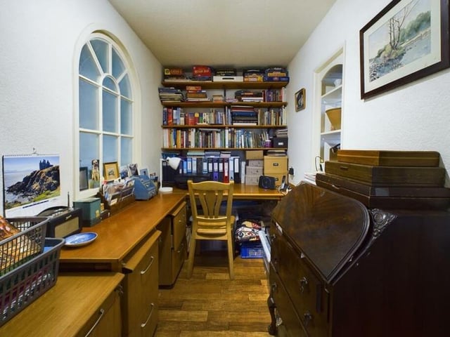A useful study or home office with arched window feature.