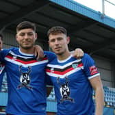 Josef Wheatley, Stephen Walker and Priestley Griffiths celebrate signing their new contracts at Whitby Town.