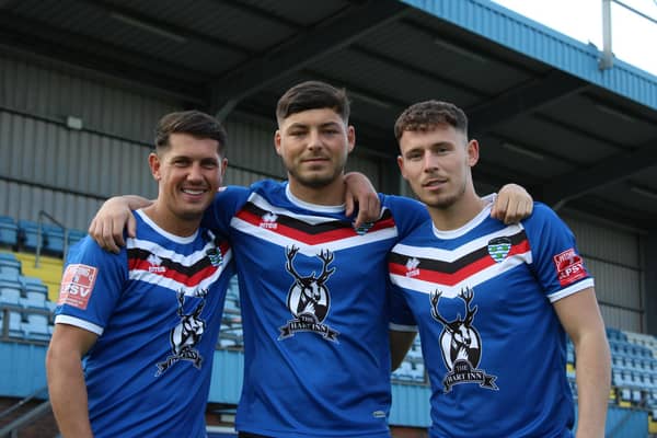 Josef Wheatley, Stephen Walker and Priestley Griffiths celebrate signing their new contracts at Whitby Town.