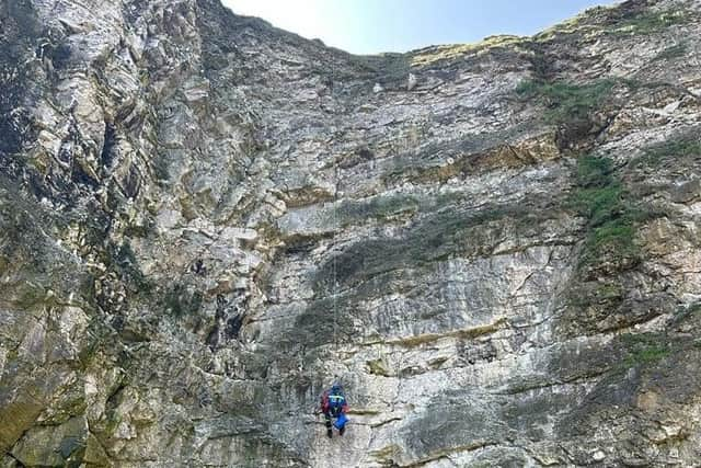 A Coastguard technician descending the 45-metre cliffs