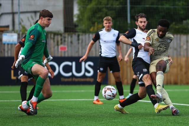 Kieran Weledji fires at the Marine goal.