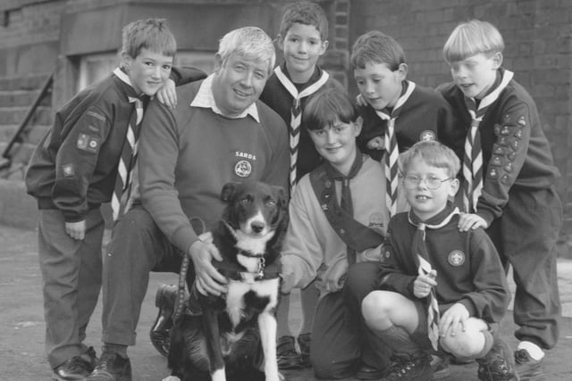 Hugh Donnolly and Tyke the Superdog meet the Scouts and Guides at their fundriasing event at Westborough Methodist Church in November, 1995. Pictured from left are Michael Parker, Christopher Jones, Hugh and Tyke, Stuart Parker, Tim Slade; front, Clair Parker and Theo Slade. 