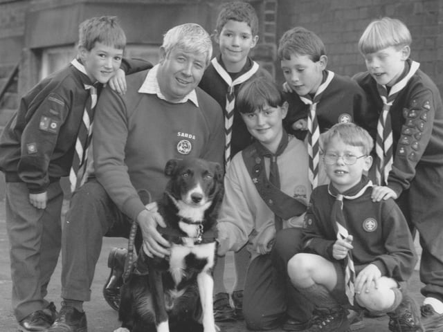 Hugh Donnolly and Tyke the Superdog meet the Scouts and Guides at their fundriasing event at Westborough Methodist Church in November, 1995. Pictured from left are Michael Parker, Christopher Jones, Hugh and Tyke, Stuart Parker, Tim Slade; front, Clair Parker and Theo Slade. 