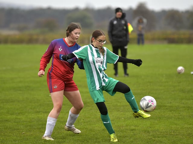 Scarborough Ladies Under-15s defender Ava Hutchings puts a Grasshoppers player under pressure
