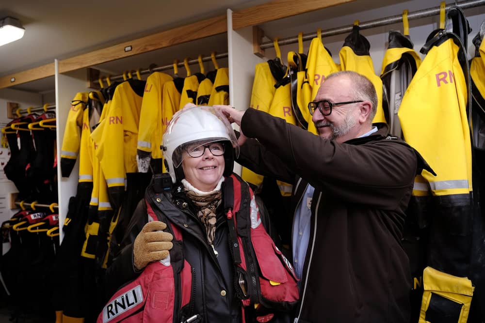 Ann tries on some of the kit with the help of Ade Evans