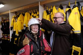 Ann tries on some of the kit with the help of Ade Evans