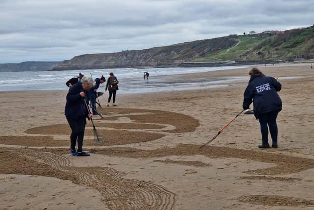 The BDMLR medics and OP Seabird helped rake the image into the sand. Photo courtesy of BDMLR.
