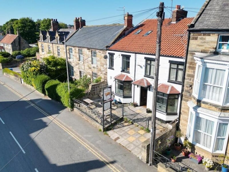 A street view of the terrace that has The Brown Cow as a mid property.