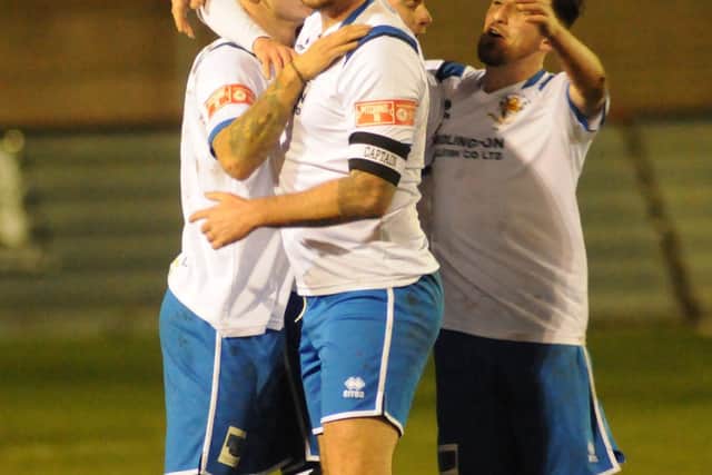 Joe Norton is congratulated for his goal by Town teammates