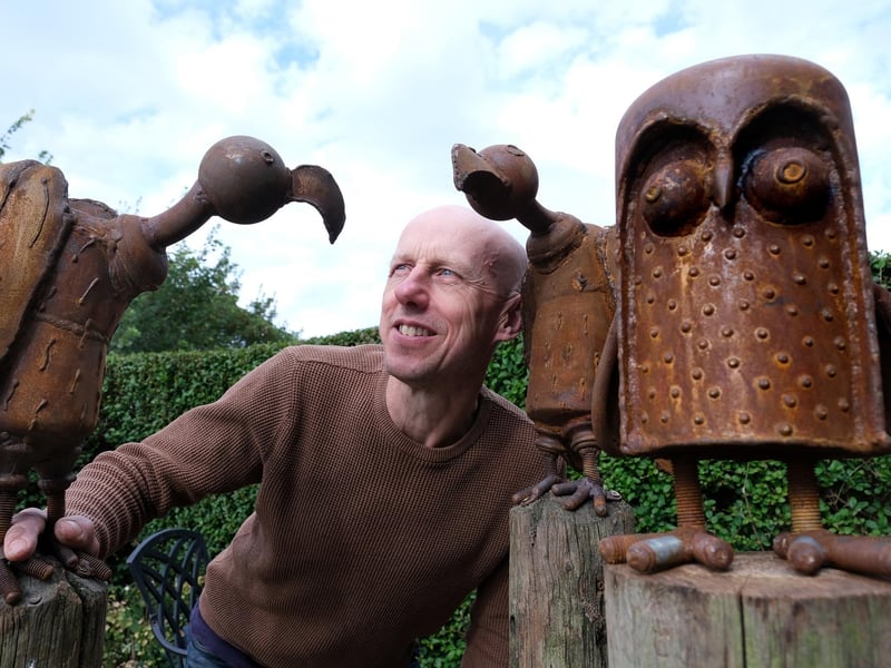 Sculptor Mick Kirkby-Geddes with his metalwork sculptures.