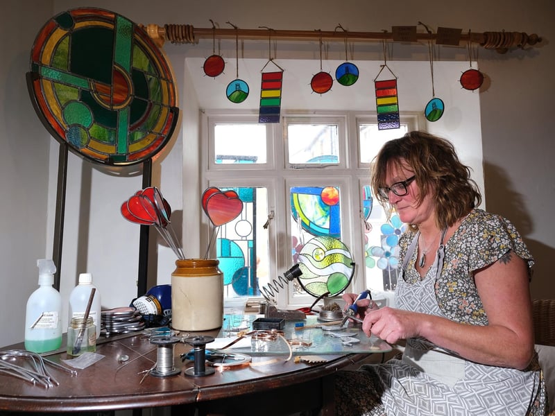 Artist Janet Fraser works on her stained glass designs.