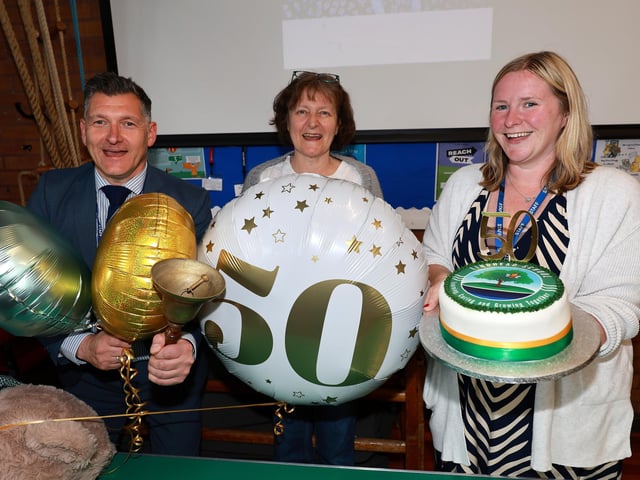Head teacher Simon England, Chair of Governors Clare Mensah and teacher and cakemaker Marie Parkins at the event