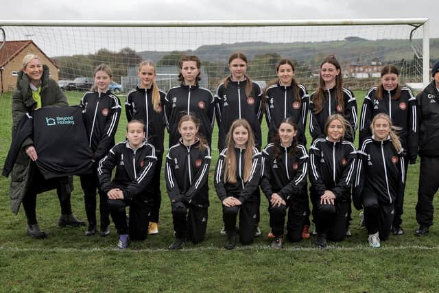 Beyond Housing Community Connector Coordinator Stephanie Lake (left) presents the new Beyond Housing sponsored strip to the Scarborough Ladies U14 team, with their Manager Colin Hepples (right).