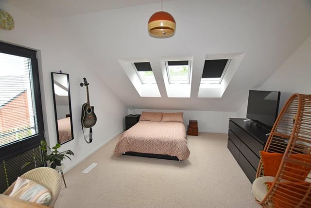 A spacious double bedroom with skylight windows.