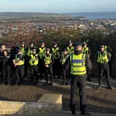 Officers receive their briefing at Oliver's Mount before deploying to execute early-morning warrants as part of Operation Tornado.