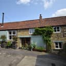 The front aspect of the three-bedroom stone cottage, that has a one-bedroom annexe.