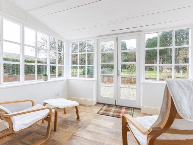 French doors lead from a conservatory to the patio and gardens.