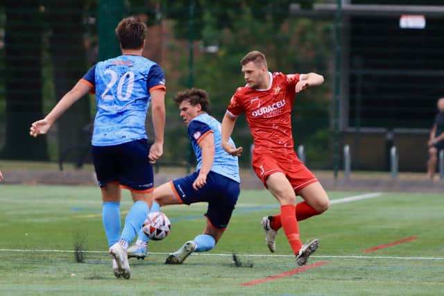 Bridlington Town's Benn Lewis looks to get the ball from former Brid star Cam Connelly. Photo by TCF Photography