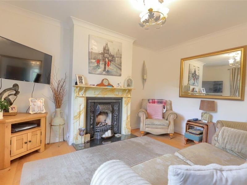 The cosy living room overlooks the garden and has oak flooring, and a cast iron fireplace with living flame gas fire.