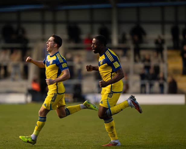 Lewis Maloney, left, celebrates his leveller with teammate Kieran Weledji. Photo by Wandering Photography
