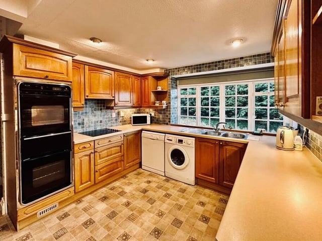 The fitted kitchen with large window in Yew Court.