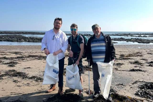 Kieran, James from the Sea Life Centre, Jason Mullen of the Green Party, on North Bay Beach during the beach clean