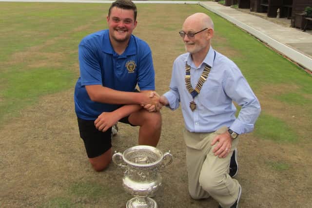 Association President Ed McCormack, right, hands Callum Malone the William Boyes Cup.