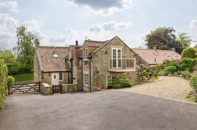 A view of Chestnut Cottage with its main bedroom balcony that looks out over the gardens.
