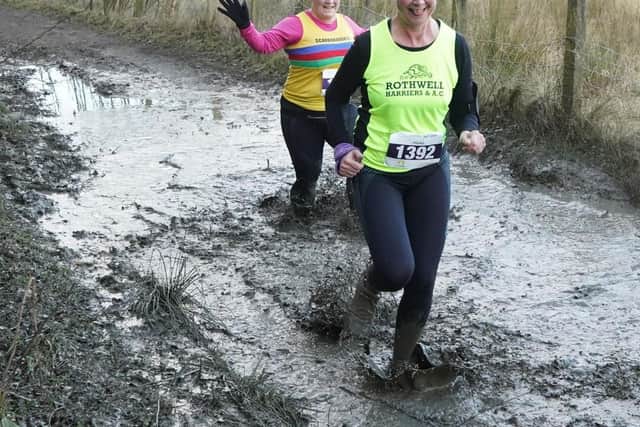 Sophie Vaughan, left, battles through the mud at Temple Newsam.
