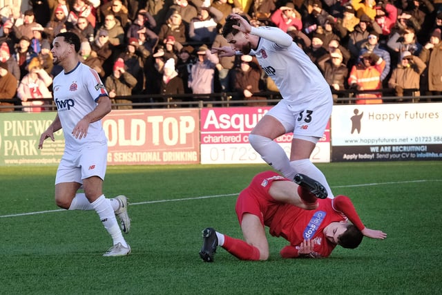 A Scarborough Athletic players is brought down to earth with a bump against AFC Fylde.