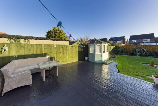 A private rear garden has a shaped lawn and a good size area of decking for sitting out in the summer.
