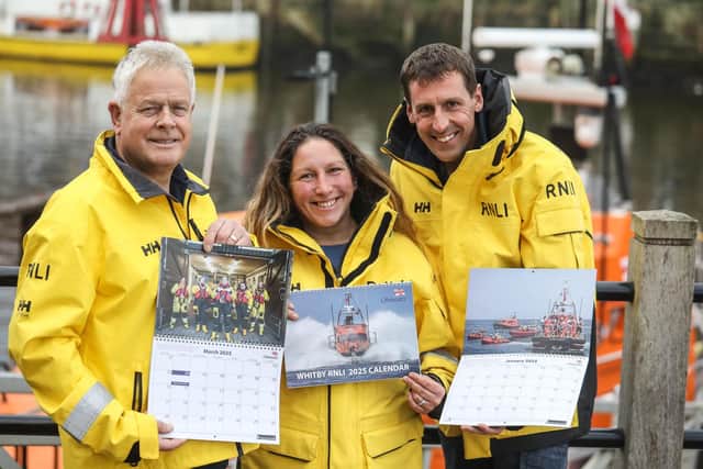 Whitby RNLI's Neil Williamson, Ally Brisby and Richard Dowson promoting the 2025 calendar.