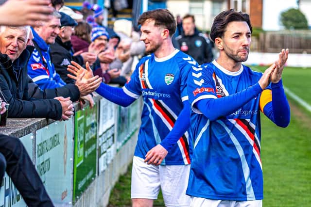 Whitby captain Layton Watts, right, and Sam Collins, thank the home fans after the draw with Hyde. Photo by Brian Murfield