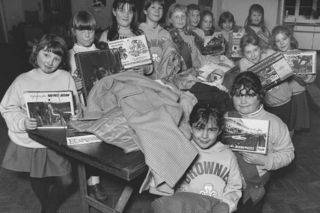 St James' Church Brownies were all set for their fundraising jumble sale in January 1995. The girls are pictured sorting through their collection of games and clothing. 