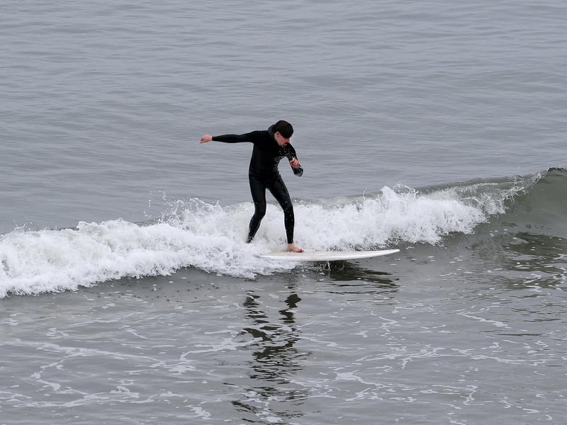 Despite the Surf competion being cancelled some sufers ventured into the calm sea to surf.