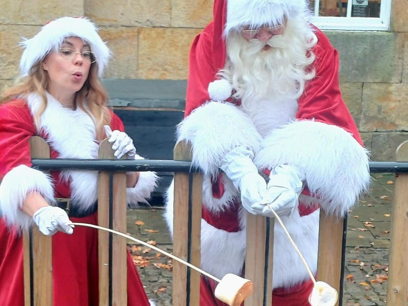 Father Christmas and Mrs Christmas toast their marshmallows. photo: Emma Atkins