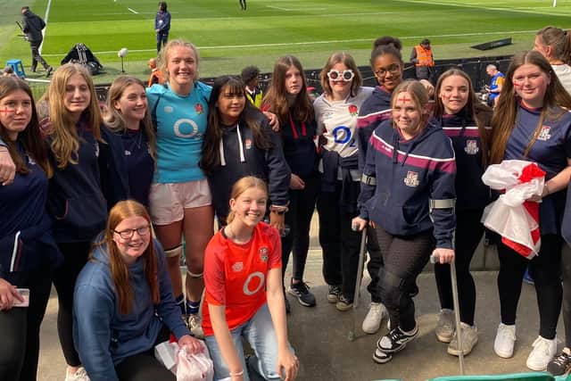 Girls rugby players line up with Zoe Aldcroft.