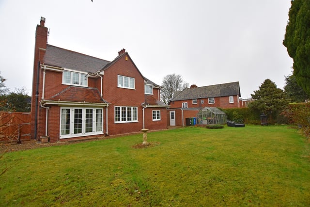 The property has a lawned, enclosed garden with established trees, shrubs and plants.