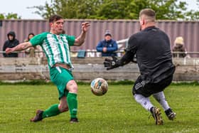 Fishburn Park's Dan Brown is closed down by the TIBS keeper. PHOTOS: BRIAN MURFIELD