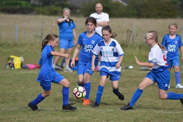 Heslerton U11s Girls Fireworks (blue) take on Driffield (blue and white) Photo: Cherie Allardice.