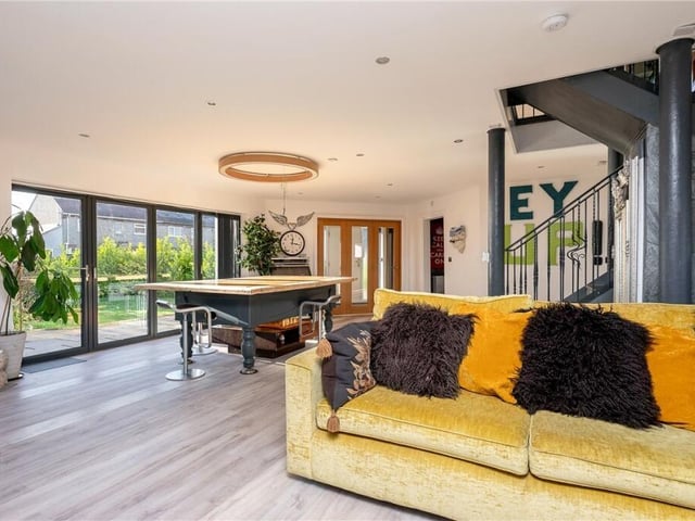 Natural light floods the home through large sections of glazing.