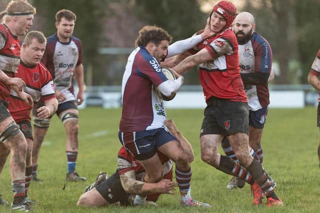 Scarborough RUFC veteran Tom Harrison gets to grips with the home players. Photo by Andy Standing
