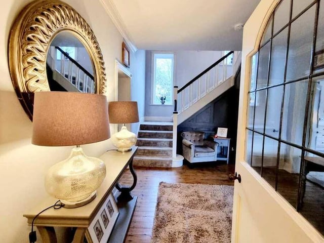 A stylish hallway leads in to the house, with a staircase up to the first floor.