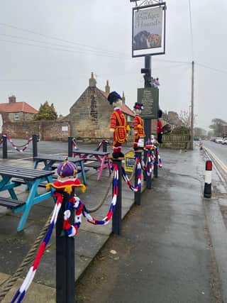 Hand-knitted Beefeaters 'guarding' the Badger Hounds, Hinderwell, for the King's Coronation.