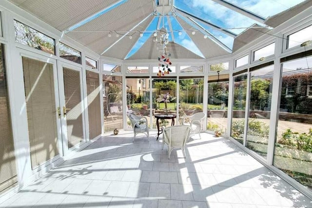 A spacious and lovely conservatory offers versatile use.