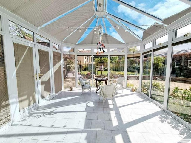 A spacious and lovely conservatory offers versatile use.
