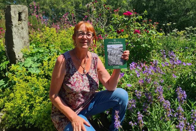 Horticulturalist Jan Hoyland with The Alchemy of Gardening book.