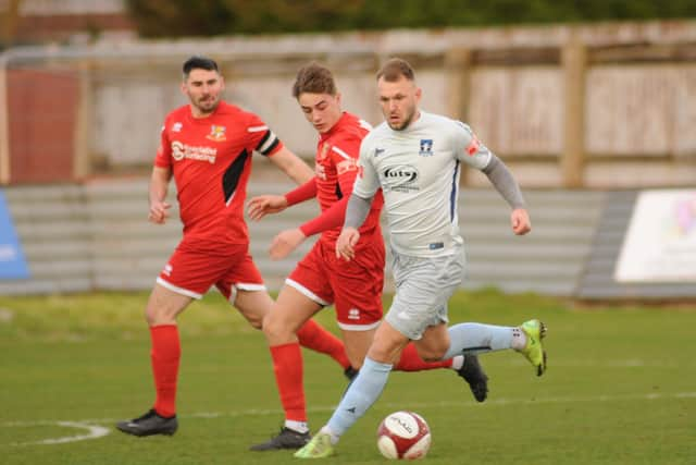 Bridlington Town's Alex Markham tracks a Dunston forward in the NPL East encounter. PHOTOS BY DOM TAYLOR