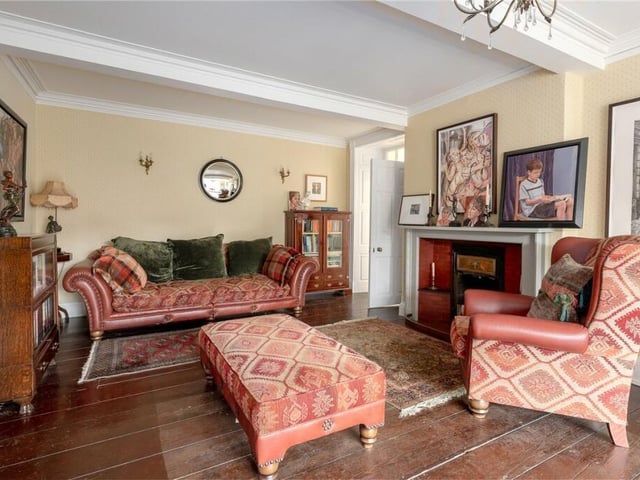A sitting room with feature fireplace.
