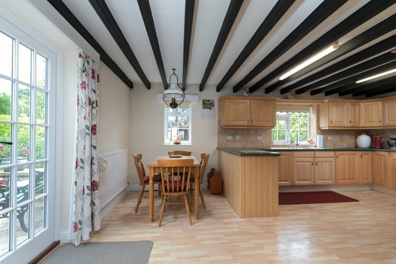 A spacious kitchen with diner has an Aga and integrated appliances.